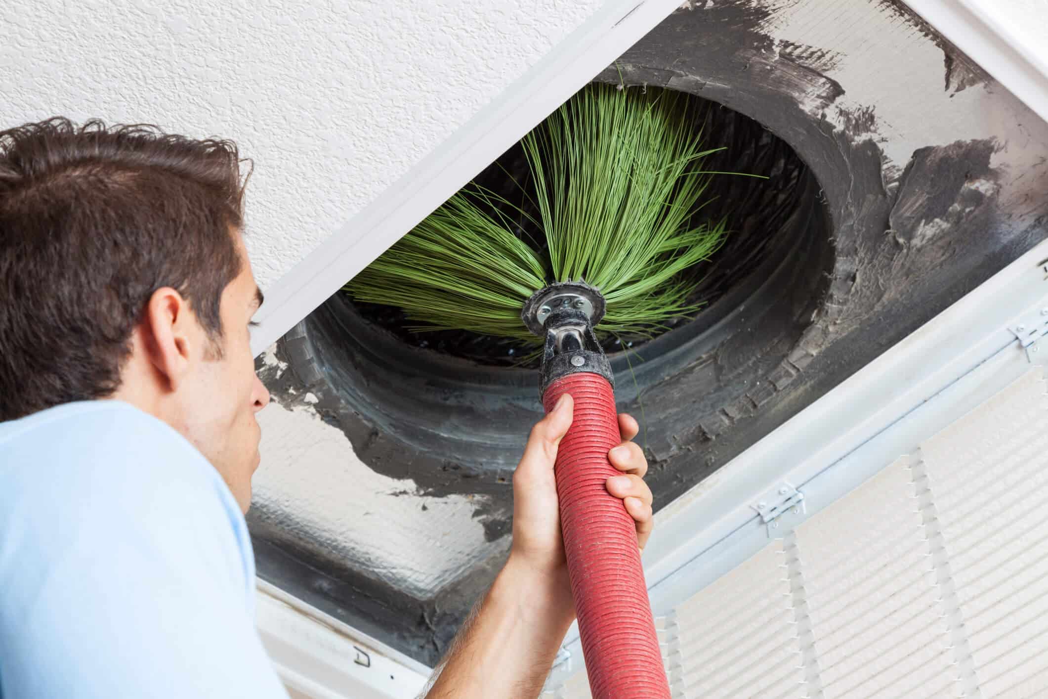 technician performing air duct cleaning