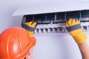 technician replacing filters in ac unit