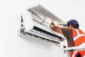 technician repairing ac unit