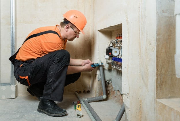 man working on plumbing